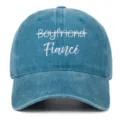 Close-up of 'Boyfriend Fiance' white embroidery on vintage washed blue denim baseball cap - Adjustable / Lake Blue (Fiance)