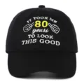 Front view detail of black cotton baseball cap with 80th birthday slogan embroidery - Adjustable / 80th Birthday Style