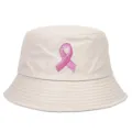 Close-up detail of beige bucket hat featuring a pink ribbon embroidery for awareness. - Off White