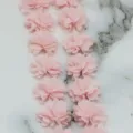 Close-up of pink chiffon flower lace trim, delicate fabric sewing accessory detail view. - Light Pink