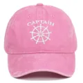 Close-up of white Captain embroidery and ship wheel logo on a pink washed cotton baseball cap - Adjustable / Pink