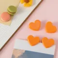 Cute mini heart-shaped plastic clips for organizing notes, photos, and snack bags neatly. - Orange