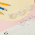 Transparent heart shaped plastic clips detail view, cute stationery for office school study. - Pure Transparent