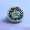 Close-up of a cute round acrylic clip featuring a festive Christmas wreath and text print. - Christmas Wreath