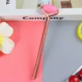 Elegant rose gold gel pen with a functional pink spiky massage roller head design - 0.5mm / Red