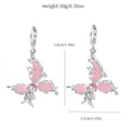 Detailed close-up of alloy crystal butterfly earrings with pink enamel and delicate rose design. - 11