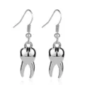 Close-up of silver metal tooth shaped hook earrings, creative quirky dental jewelry detail. - Silver