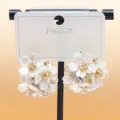 Detailed close-up of white flower cluster earrings with sparkling rhinestones on card stand. - C-597 Silver