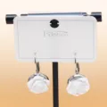 Detailed close-up view of elegant white rose flower drop earrings with silver hooks on card. - C-598 Silver