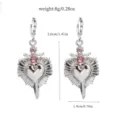 Detail shot of alloy rhinestone heart dagger earrings showing dimensions and sparkling pink stones. - 25