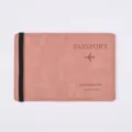 Close-up of pink PU leather passport cover detail with elastic band and travel branding. - Pink
