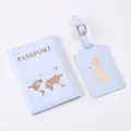 Details of light blue PU passport holder and luggage tag set with gold foil world map. - Light Blue