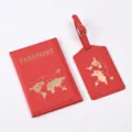 Red PU leather passport cover and luggage tag set with gold world map detail closeup view - Bright Red
