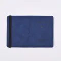 Closeup view of blue PU leather passport cover featuring elastic band and debossed logo text. - Dark Blue