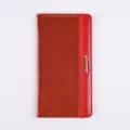 Red glitter PU leather passport cover with elastic band and metal clasp detail closeup. - Red