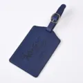 Close up of deep blue PU leather luggage tag with embossed adventure quote and metal buckle. - Dark Blue