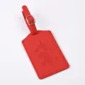 Red PU leather luggage tag with world map embossing and metal buckle, ideal travel accessory detail. - Bright Red