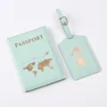 Detailed view of mint green PU leather passport cover and luggage tag set with gold foil world map. - Green