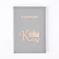 Detailed view of grey PU leather passport holder with gold King crown print and stitching. - Gray