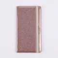 Close-up view of sparkly pink glitter PU leather passport holder showcasing elastic band closure. - Rose Gold