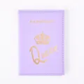 Close-up of purple PU leather passport cover with gold foil crown and queen text design. - Purple
