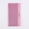 Detailed view of pink glitter PU leather passport cover with elastic band and metal accent. - Pink