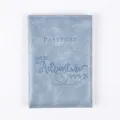 Detailed view of blue PU leather passport cover with adventure travel quote embossing. - Folded Size 14*10cm / Light Blue