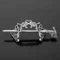 Close-up detail of vintage silver Viking dragon hair pin with intricate Celtic knot design. - D-260
