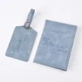 Detailed view of blue PU leather passport holder and luggage tag travel set with embossed quote. - Ice Blue
