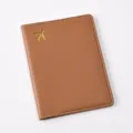 Brown PU leather passport cover with gold foil airplane pattern and white edge stitching. - Passport Cover / Brown