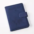 Detail view of blue PU leather passport holder featuring debossed world map and magnetic buckle. - Passport Cover / Dark Blue