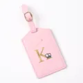 Pink leather luggage tag with gold letter K and cute airplane travel design for suitcases. - Letter K / Pink