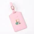 Close up view of a pink leather luggage tag featuring a gold letter E and travel design. - Letter E / Pink