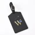 Black PU leather luggage tag detail, featuring gold letter W, buckle strap and camera icon. - Letter W / Black
