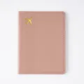 Pink PU leather passport cover with gold airplane design and white stitching details. - Passport Book / Pink