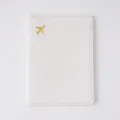 White passport cover with golden airplane pattern, minimalist PVC document holder for travel. - Passport Book / White