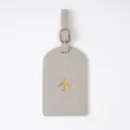 Grey PVC luggage tag with gold airplane pattern, durable passport cover for travel. - Luggage Tag / Gray