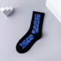 Black mid-calf casual skate socks featuring a striking blue paisley pattern panel. - 36-43 / Vertical Striped Paisley Socks in Black