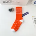 Vibrant orange crew socks featuring a classic white paisley bandana pattern for stylish wear. - 36-43 / 2022 Paisley Pattern Orange Socks