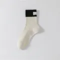Korean speckle yarn crew socks with color-block black cuff and small woven label detail. - 36-44 / Black & Beige