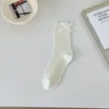 White slouchy socks for women featuring a cute side bow, lightweight cotton mid-tube design. - 36-40 / Cream White
