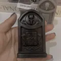 Black skull tombstone scented candle for Halloween party decoration, spooky gothic gift item. - Black