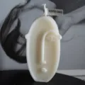 Abstract human face scented candle, European aesthetic wax home decor gift item main view. - White