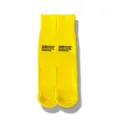 Close-up detail of yellow ribbed mid-calf socks featuring stylish printed English text. - One Size / Yellow