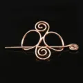 Closeup view of the vintage rose gold metal Viking Celtic hair pin, showing intricate spiral design. - D-269