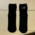 Black cotton short socks with a trendy melting smiley face embroidery, casual style for daily wear. - One Size / Black