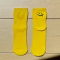 Yellow cotton short socks featuring a cute embroidered melting smiley face design for daily wear. - One Size / Yellow