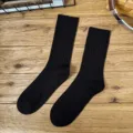 Classic black ribbed mid-calf socks for men and women, versatile casual solid color design. - One Size / Regular Thick Gauge - Black