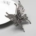 Pince a cheveux papillon en metal gris gunmetal, accessoire elegant pour femme au quotidien. - F-42
