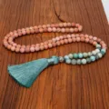 Detalle de primer plano de collar Mala de 108 cuentas con piedras veteadas y borla azul - Collar